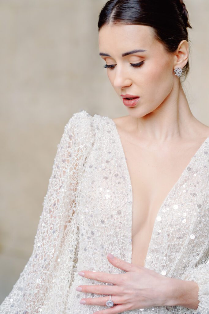 Paris pre-wedding session at the Louvre with bride in a sequined gown with a full train, long sleeved, deep plunging neckline and back, photographed by Italy destination photographer